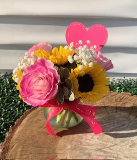 Sunflowers, and pink roses, baby breath & fresh greens designed in a darling globe glass vase!