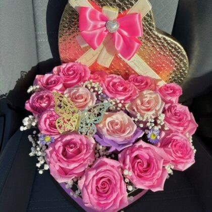 Pink roses beautifully arranged in a heart shaped box.