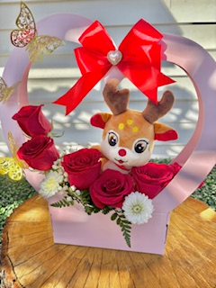 Christmas Deer floral design, Elegant Deer plush included in the fresh flower arrangement, Christmas floral arrangement, Festive Antler arrangement, Graceful Deer inside a heart shaped box surrounded with red roses.