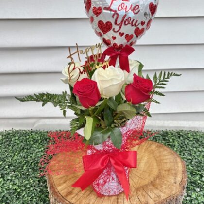 Red and white roses in a vase.