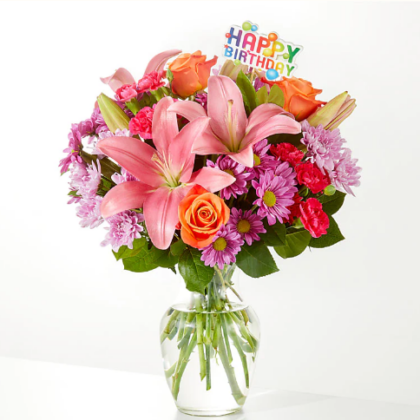 pink roses and pink Lilly mixed with fresh flowers arranged in a vase