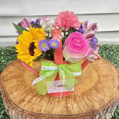 Spring flowers and roses in a Water Can fresh flower arrangement