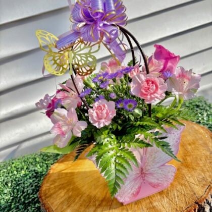 fresh flower arrangement in a pink basket